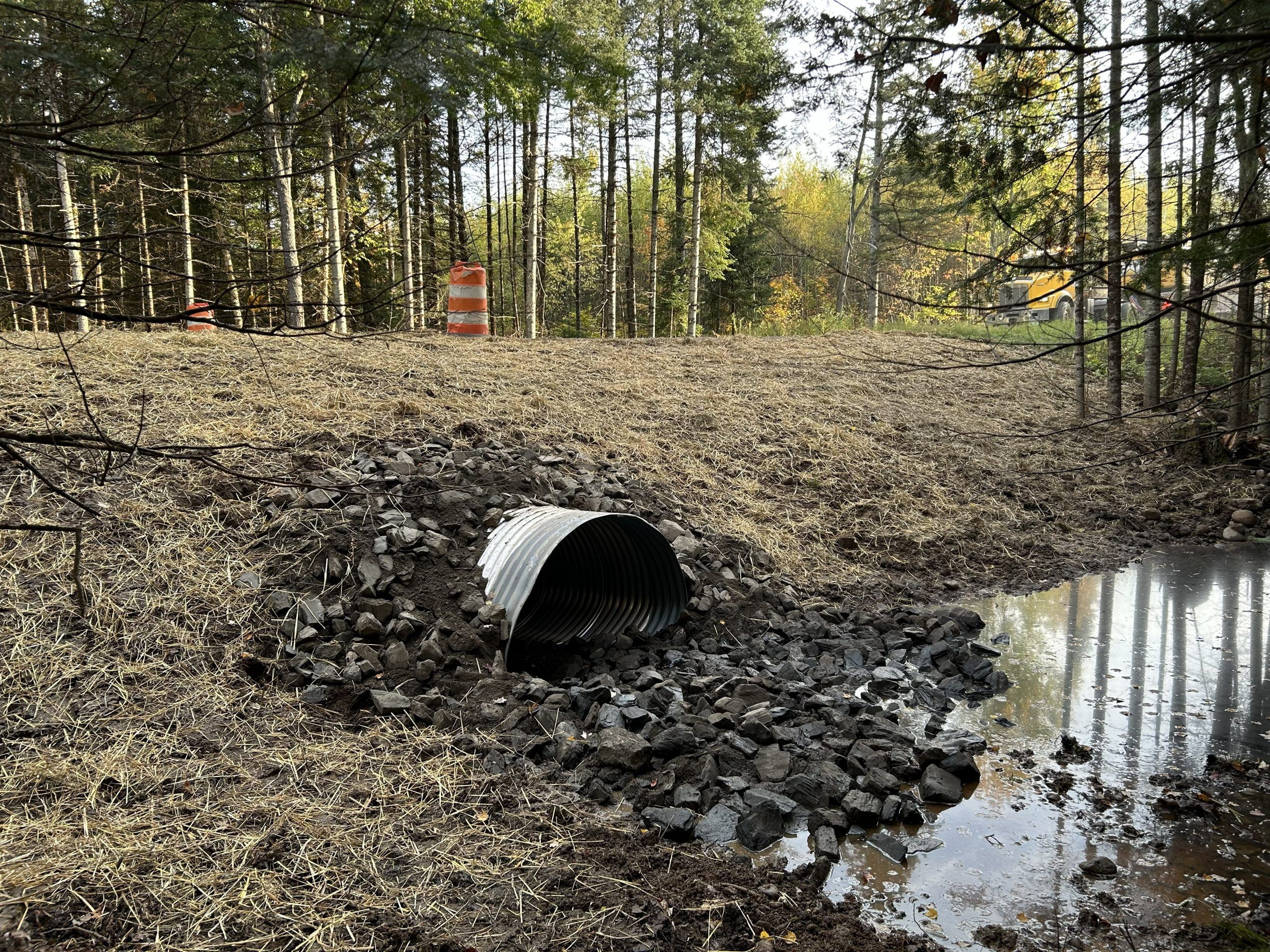 Water flows through the culvert beneath Baumgartner Rrd.